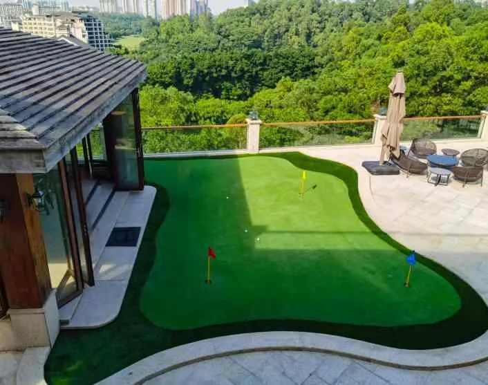 Custom golf putting green installed beside a terrace